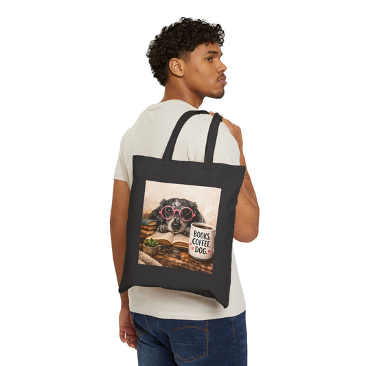 Man carrying a black tote bag with a dog design featuring a book and coffee cup.