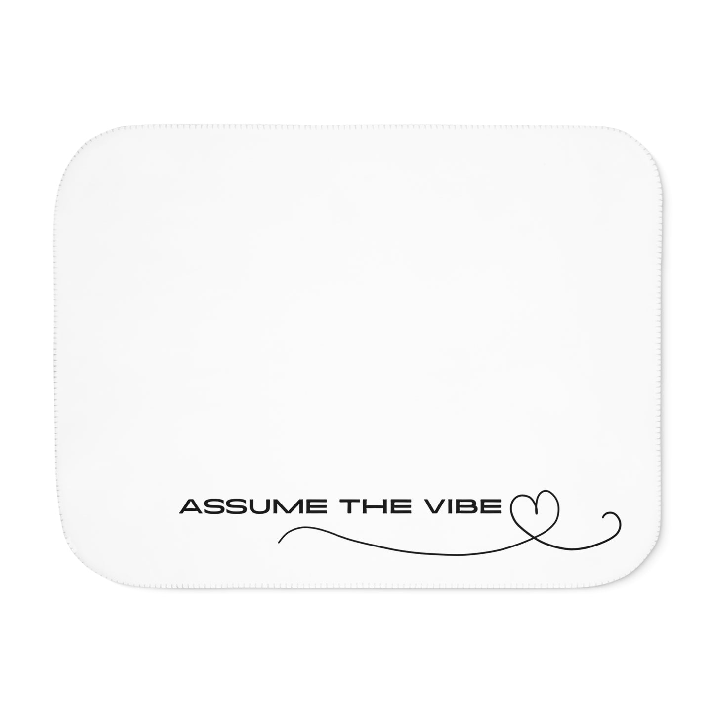 White rectangular blanket with 'Assume the Vibe' text on a white background