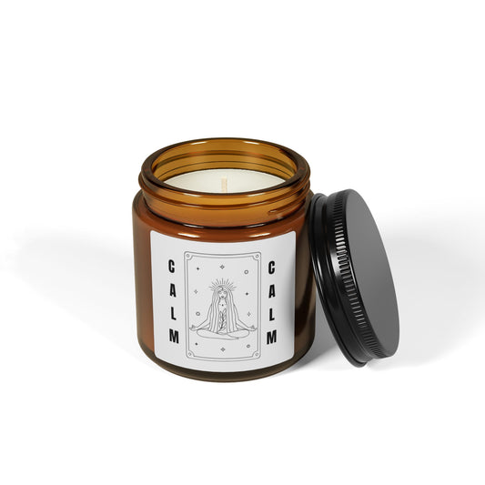 Candle in an amber jar with a black lid on a white background