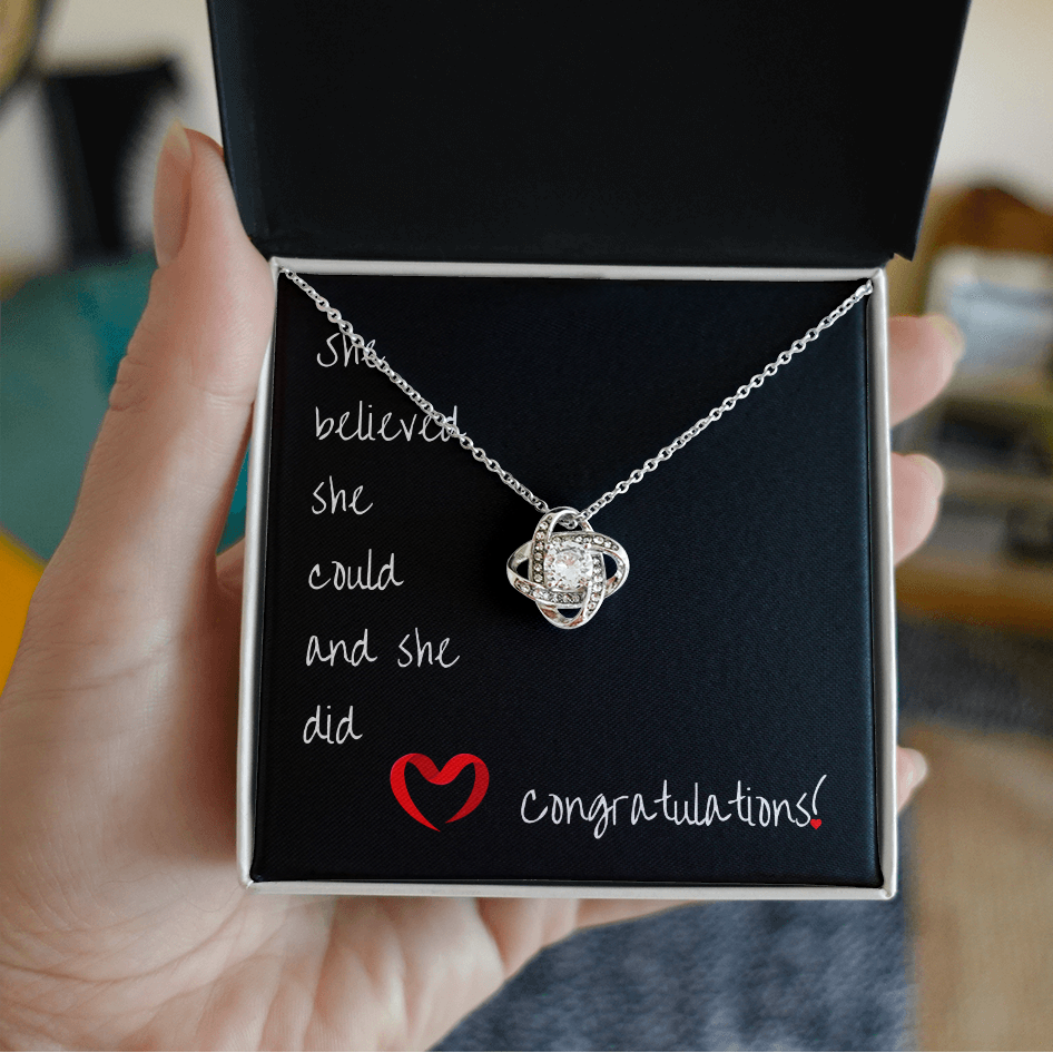 Necklace in a box with motivational message held by a hand
